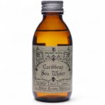 Rituaalvesi Caribbean Sea Water pruun klaaspudel valgel taustal